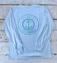 Load image into Gallery viewer, Light blue long-sleeve t-shirt with a teal and blue anchor graphic for Lewes, Delaware, featuring 'LEWES DELAWARE 1631' text, laid flat on a distressed white wooden surface.