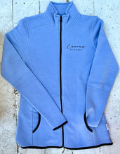 Load image into Gallery viewer, Blue full-zip fleece jacket featuring 'Lewes Delaware' text, black zipper, black trim on pockets, cuffs, and hem, laid flat on a distressed white wooden surface.