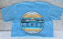 Load image into Gallery viewer, Sky blue t-shirt with a circular back graphic featuring a golden sunset over blue water, text 'Lewes Delaware Est. 1631 Outdoor Adventure' and 'Weekends, Weekdays, Whenever', with crossed paddles.