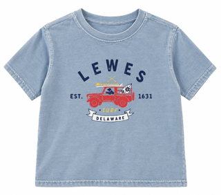 Lewes Surf Dog Jeep Youth Tee in Washed Blue Jean with a navy Lewes arched over a red jeep carrying a black dog and surfboards, Est. 1631, and a Surf Delaware banner