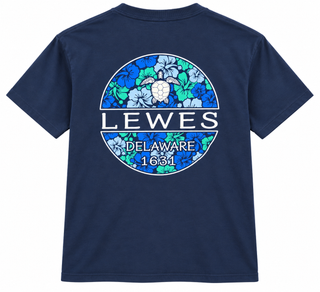 Lewes Sea Turtle Tee in Reactive Navy, back view, with a sea turtle over blue and green hibiscus flowers in a Lewes Delaware 1631 circle