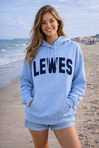 woman wearing blue Lewes hoodie on the beach 