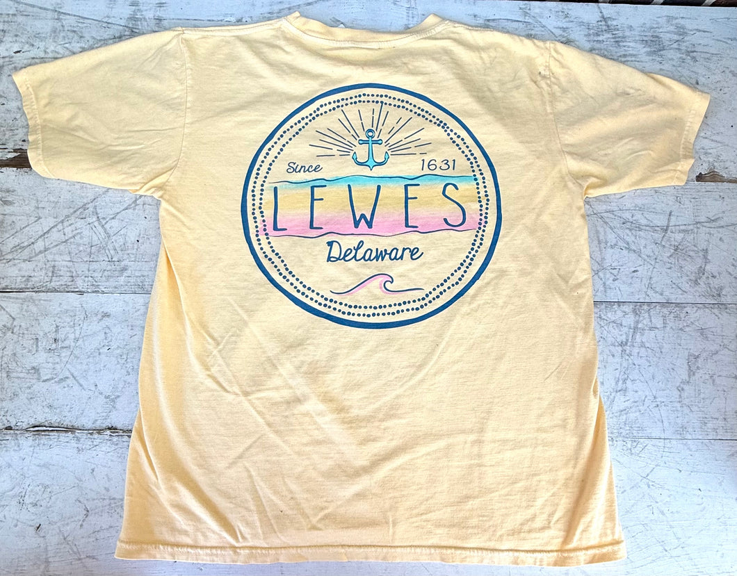 Back view of a light yellow short-sleeve t-shirt featuring a circular graphic with 