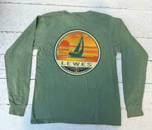 Load image into Gallery viewer, Back view of a Dorm Green long-sleeve t-shirt featuring a large circular graphic of a sailboat against an orange and yellow sunset with &quot;LEWES DELAWARE&quot; text and &quot;Established 1631&quot; with an anchor symbol.
